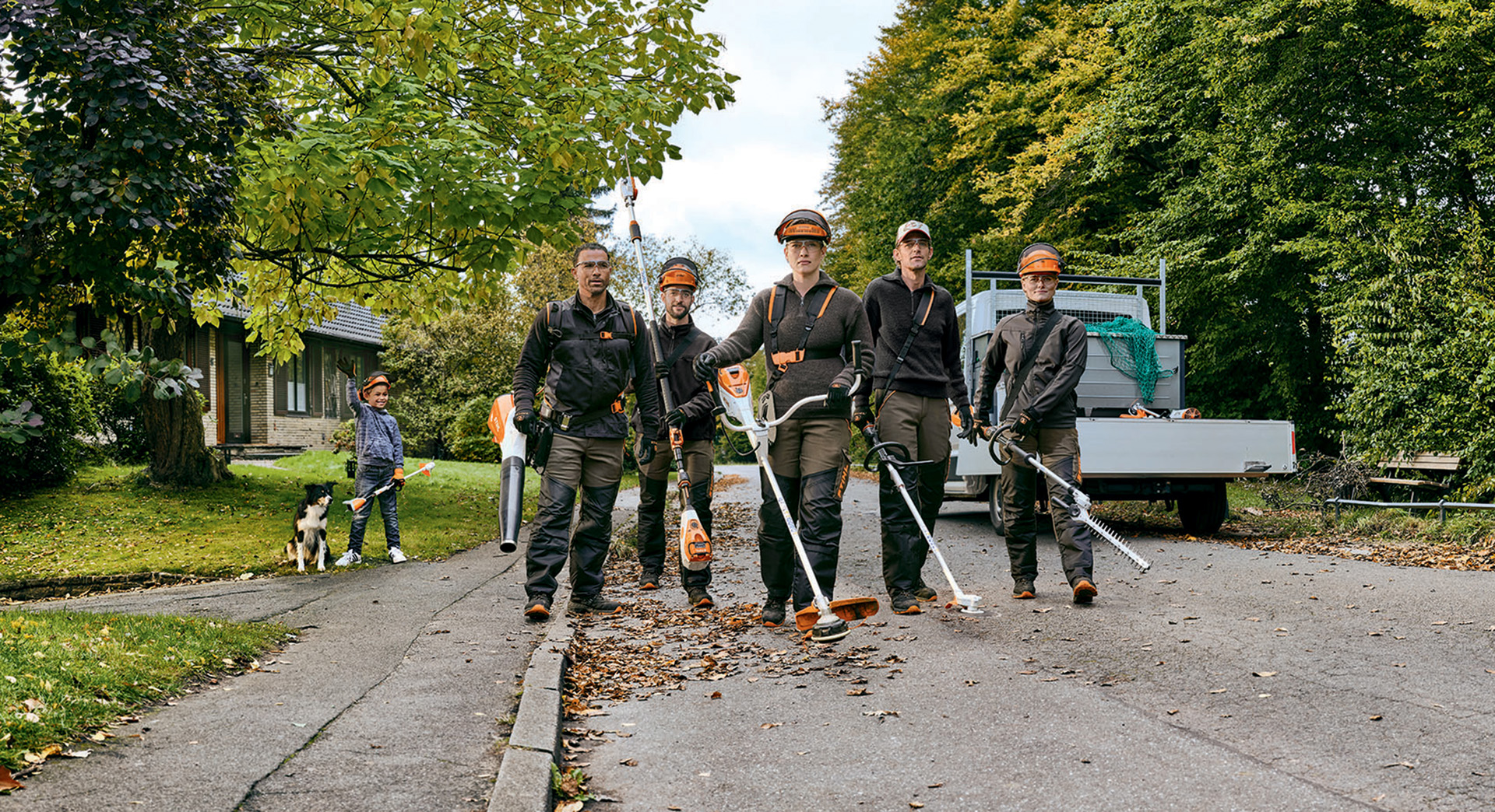 Een team van hoveniers met professionele accumachines van STIHL aan het werk in een straat.